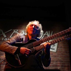 John Doan peforms at the Six Bar Jail with the harp guitar.
